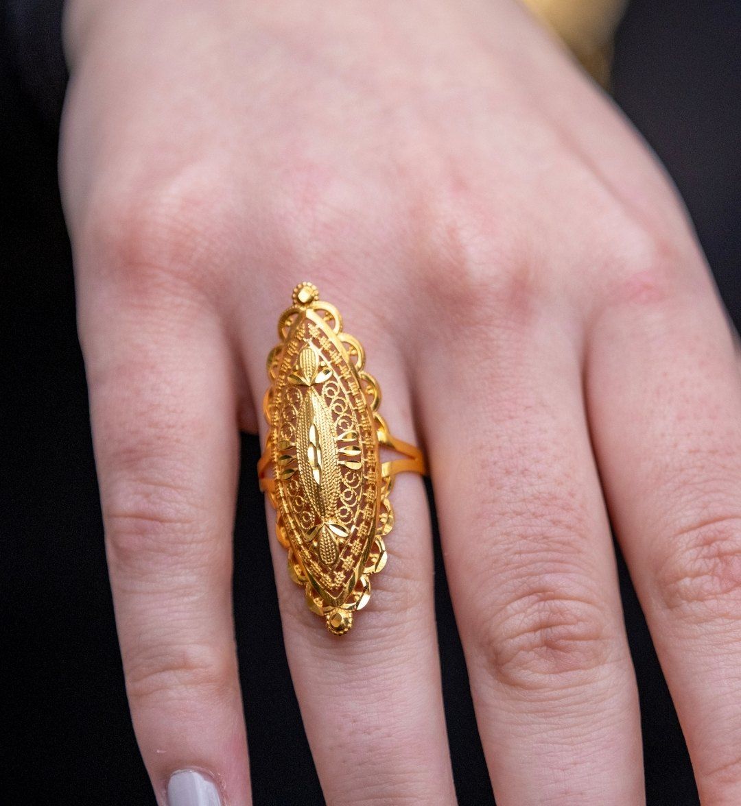 Long marquise-shaped Ottoman-style gold ring with filigree work on the finger